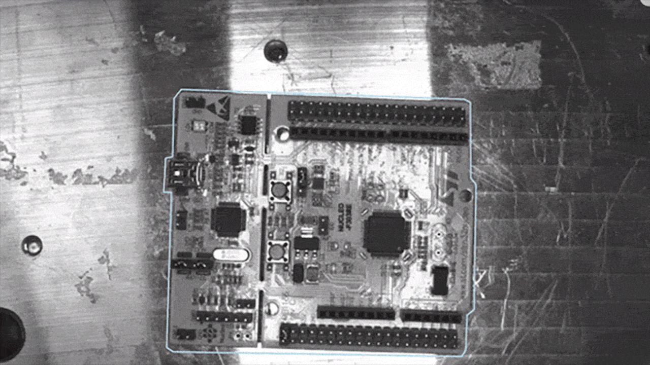 An electronic PCB is placed under a camera and scanned by Inspekto to check for defects like solder bridges, missing or misaligned components, ensuring reliable quality and reducing rework.