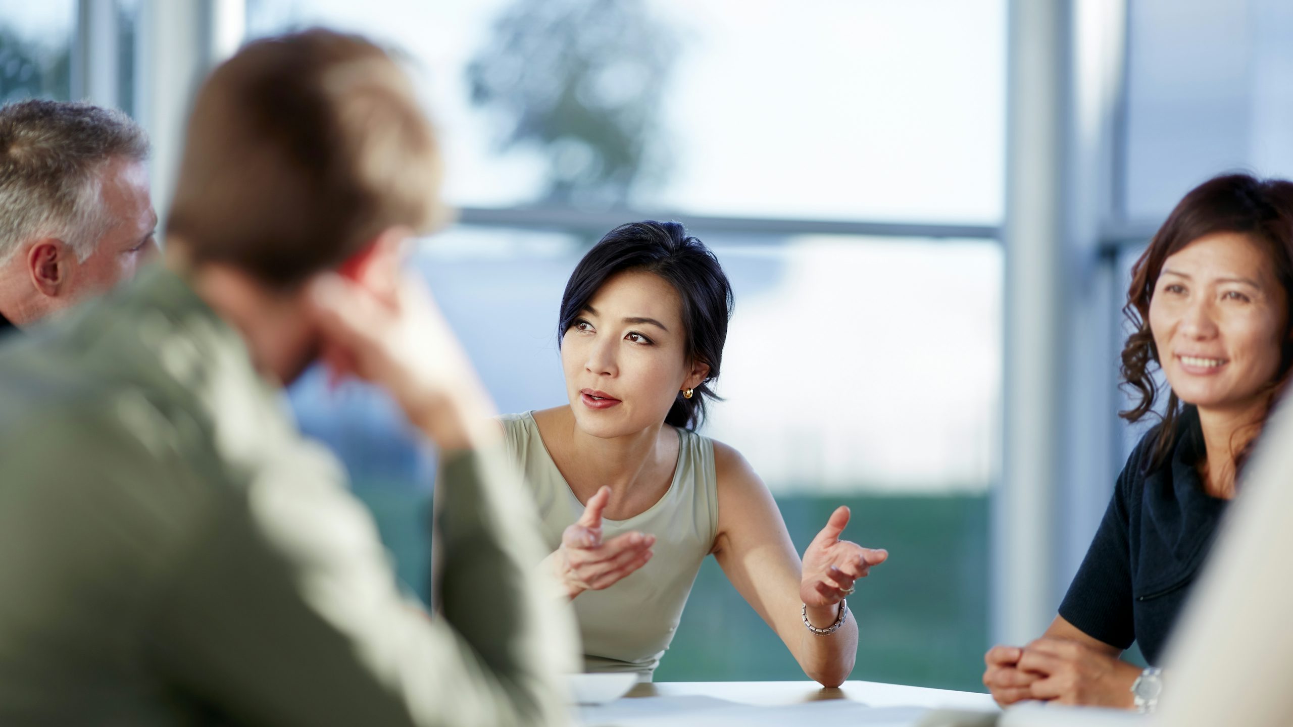 Group of colleagues sitting around a table having a discussion.