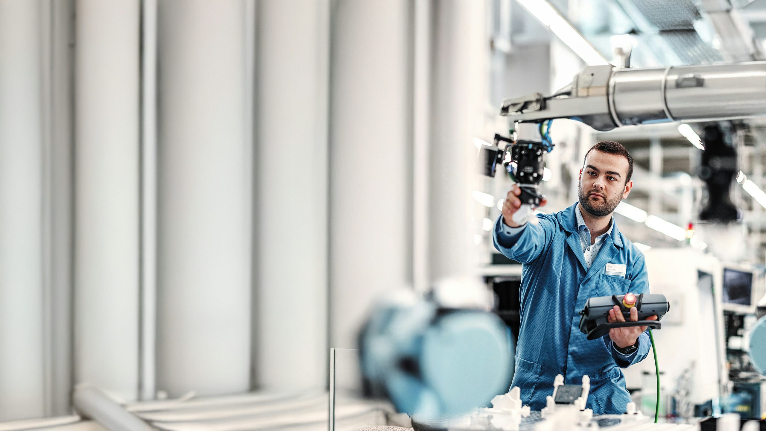 Man programming a machine in a factory.