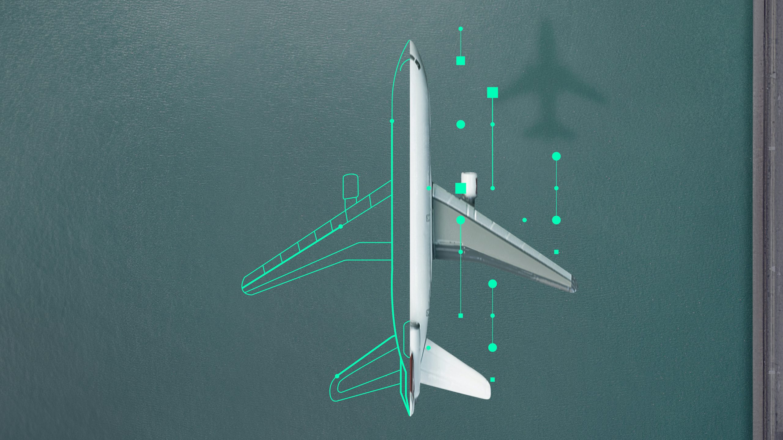 A top-down view of an airplane on a dark blue surface, with green digital outlines and data points suggesting analytics or design.