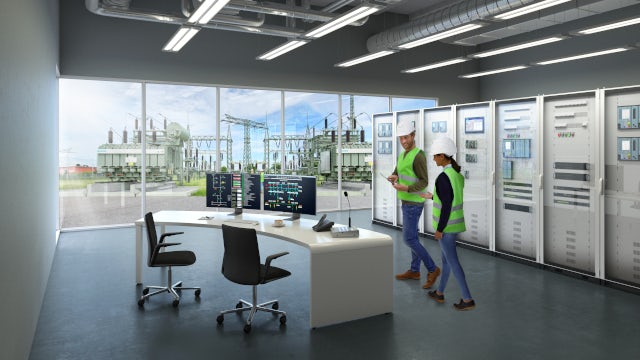 two workers in the central office of the digital substation