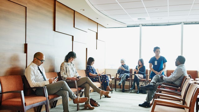 A group of people in a meeting, possibly discussing a project.