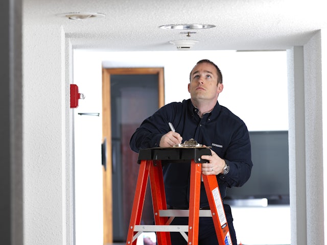 A promotional image of an onsite Services Test and Inspection of a Fire Sprinkler