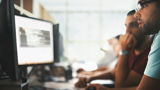 A group of software developers working together in an office.