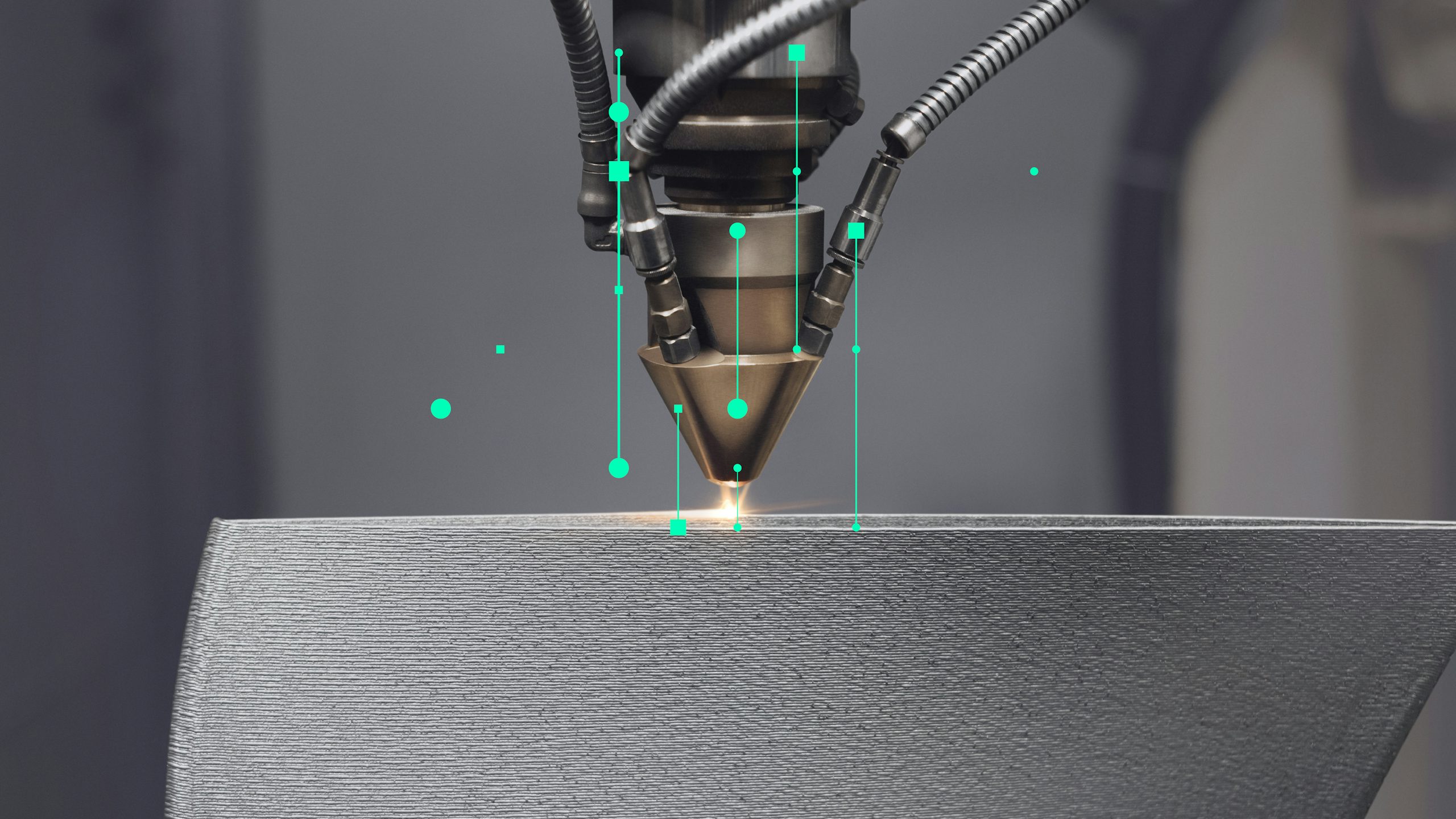 A close-up shot of an industrial 3D printing nozzle creating a metallic object, with digital green lines and dots radiating from the nozzle, symbolizing data flow.