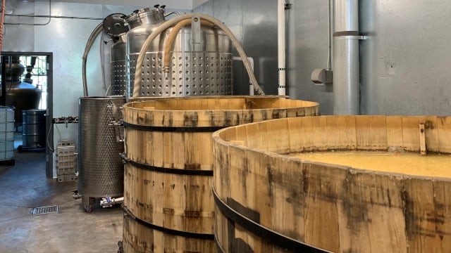 Production area at Marble Distilling showing wooden fermentation tanks and stainless‑steel process equipment used in craft spirits manufacturing.