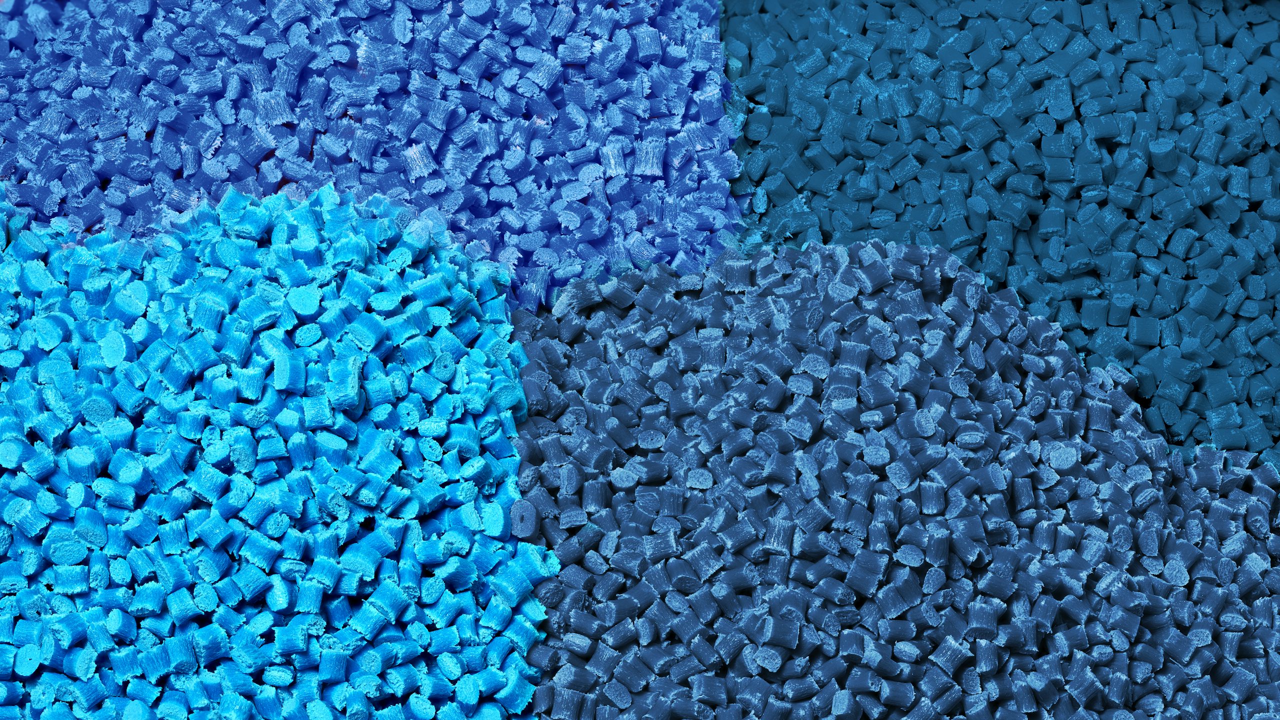 Plastic bottles and containers floating in water, with a hand reaching out from below the surface