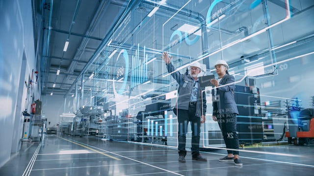 Two professionals viewing VR projections of generative AI data in a factory setting.