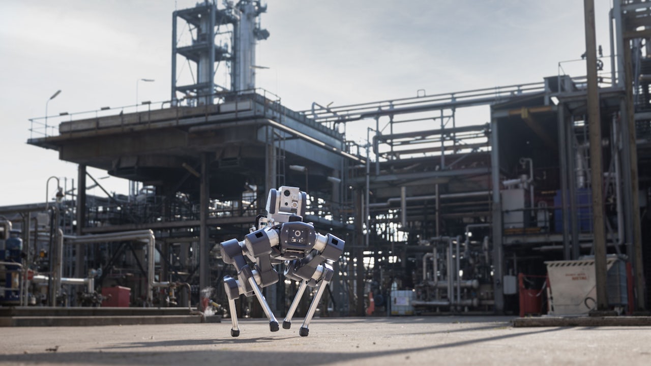 A robot is inspecting a mission outdoors, possibly in a forest or mountainous area.