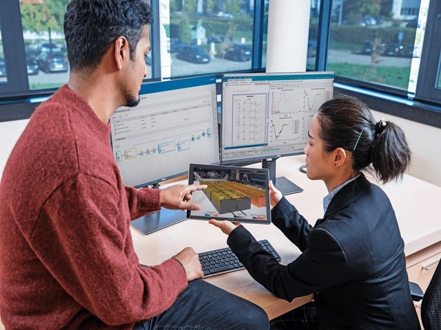 Image showing two engineers using Siemens Teamcenter to accelerate battery development.