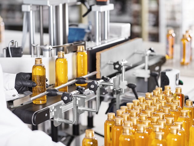 A factory line with machines and equipment for beauty cosmetics manufacturing.