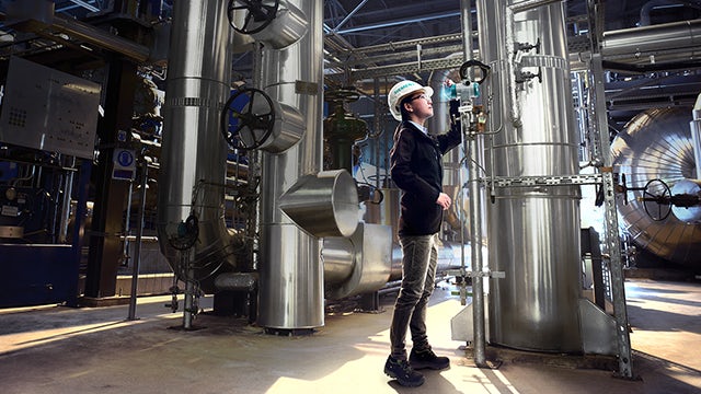 Siemens' employee inspecting machine module.