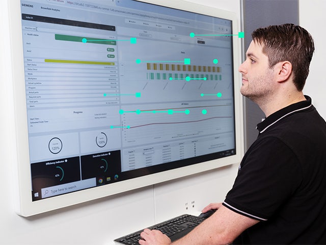 Using Brownfield Analytics, a man monitors his shopfloor KPIs.