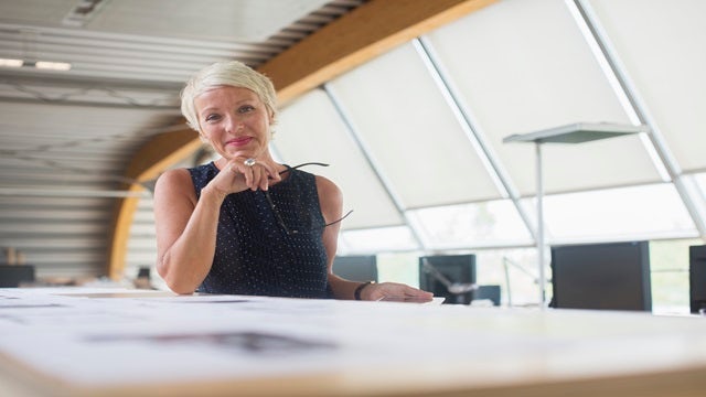 Business woman smiling in an office.