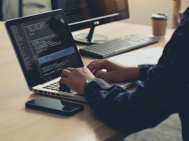 Man working at laptop exploring Building X API connections.