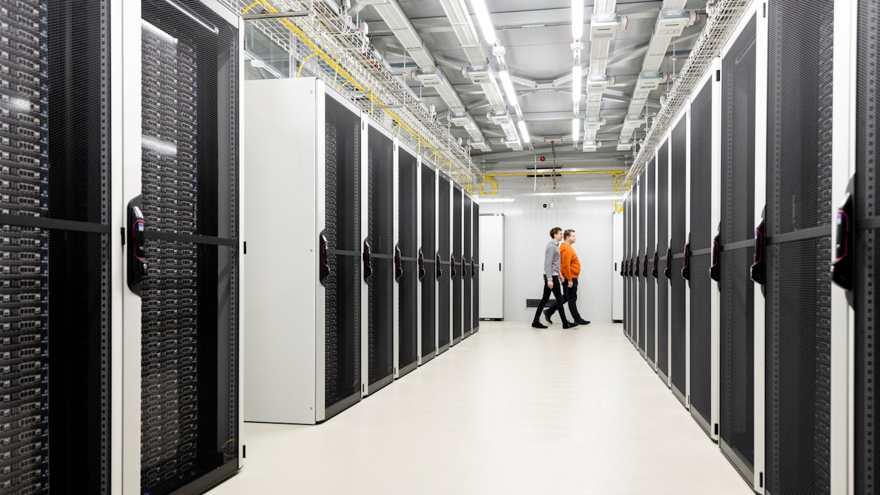 Two men walking through a data center facility
