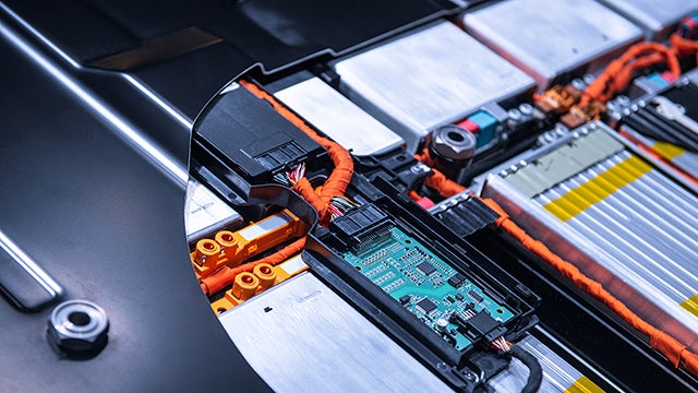 A computer with its back panel cut away, showing its inner components