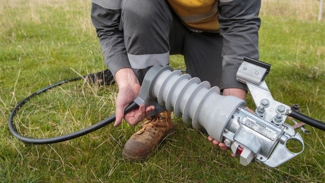 Lineman holding a Fusesaver