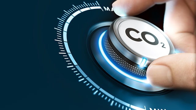 A dial with a green arrow pointing to the right, indicating a process of chemical recycling with CO2.
