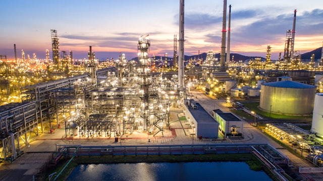 A biorefinery facility with a large tank and machinery in an industrial setting.
