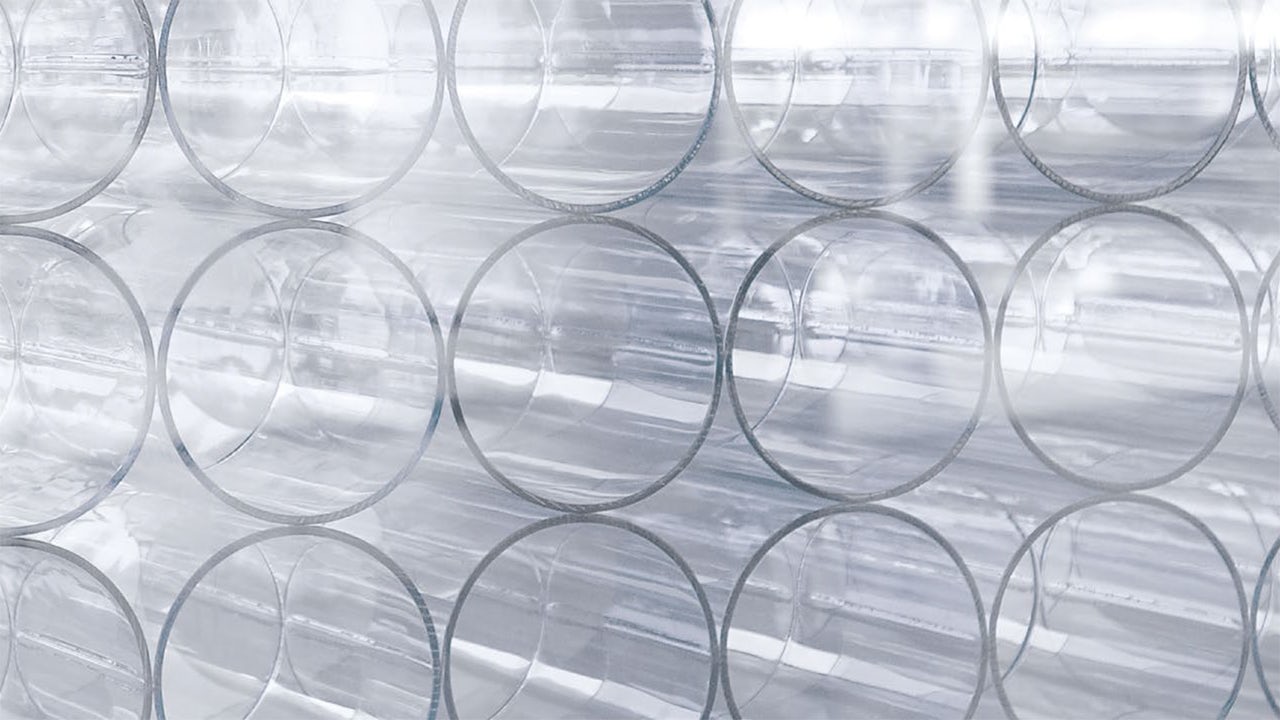 A visual representation of a glass with a reflection of a person and a document, symbolising integrity and compliance.