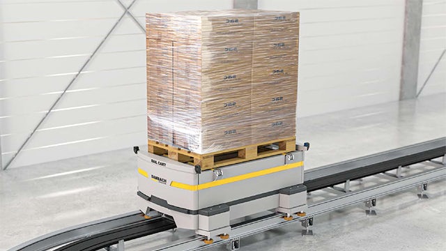 A warehouse with a large number of storage boxes and shelves, and a person standing in front of the shelves.