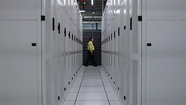 Person walking in a data centre facility.   