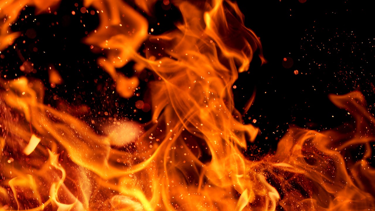 Close up of fire flames with sparks on a black background