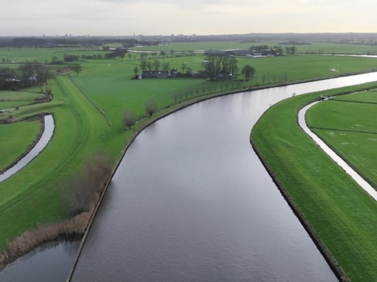 Aerial view of river winding through farmland