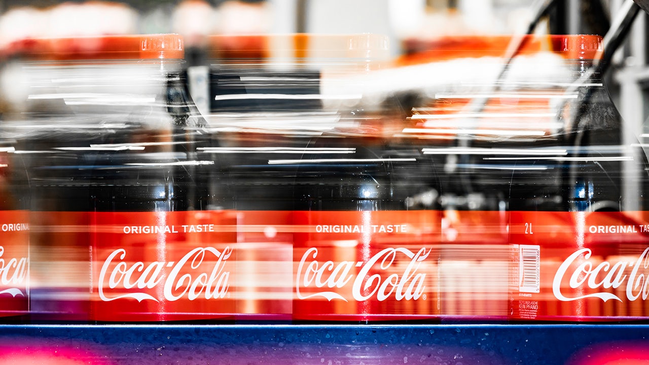 Energy consumption graph with cola bottle, comparing usage and social impact in a data visualization design.