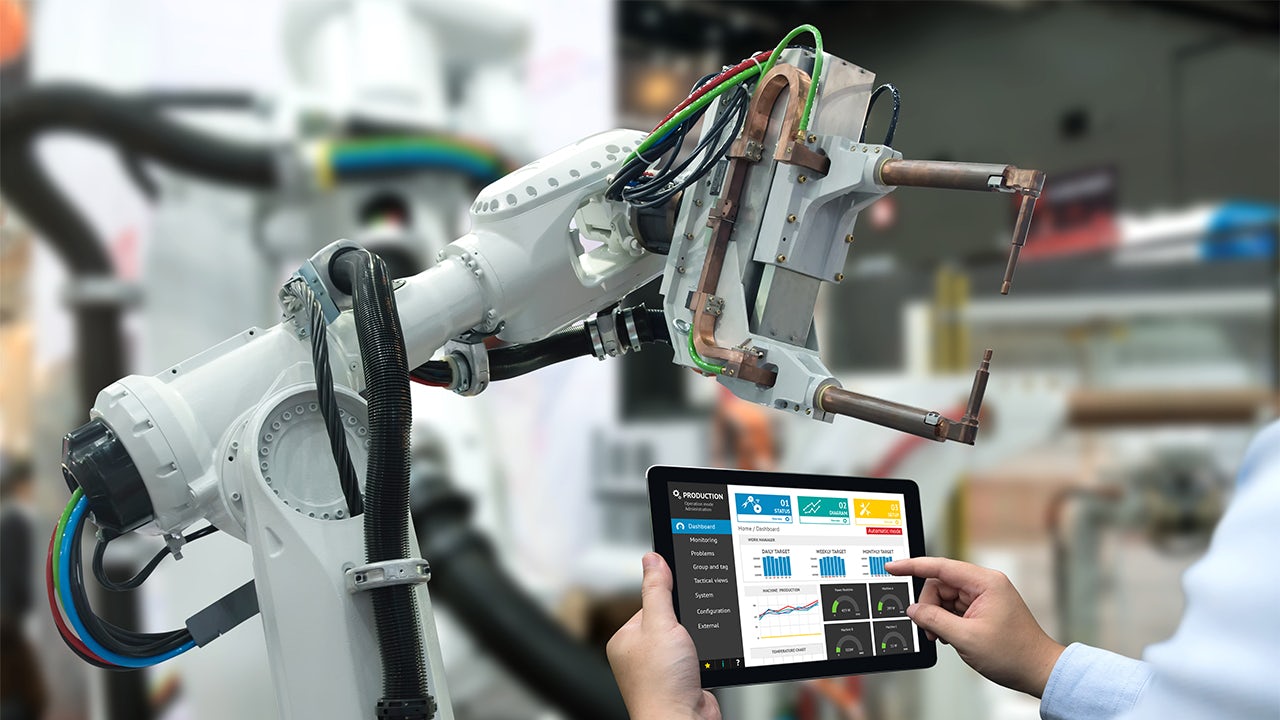 Automotive engineer using standardisation tools on a tablet.