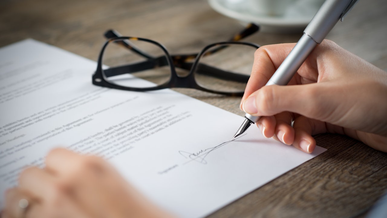 Signing a document.