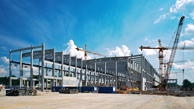 A factory automation building construction solutions whitepaper cover with a factory image in the background.