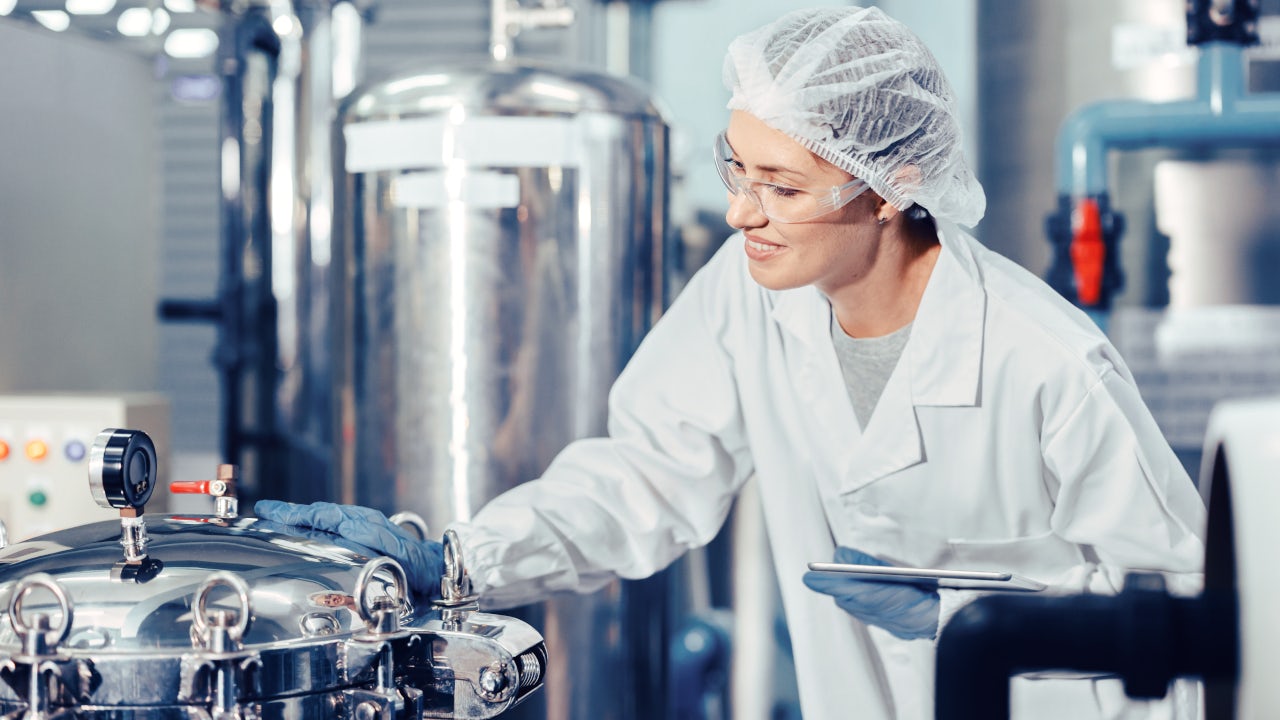 hygiene staff worker in foods and drinks clean factory. working women in water plant industry quality control check.