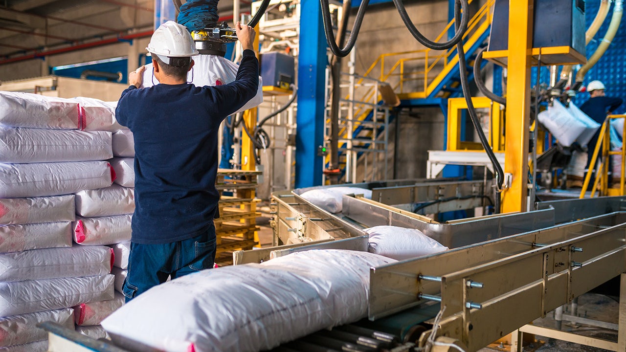Bags of fertilizer stacked in a warehouse.