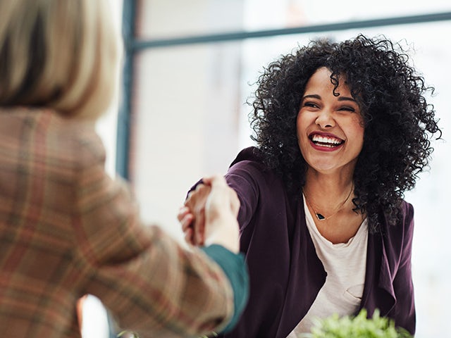 A woman congratulates another woman