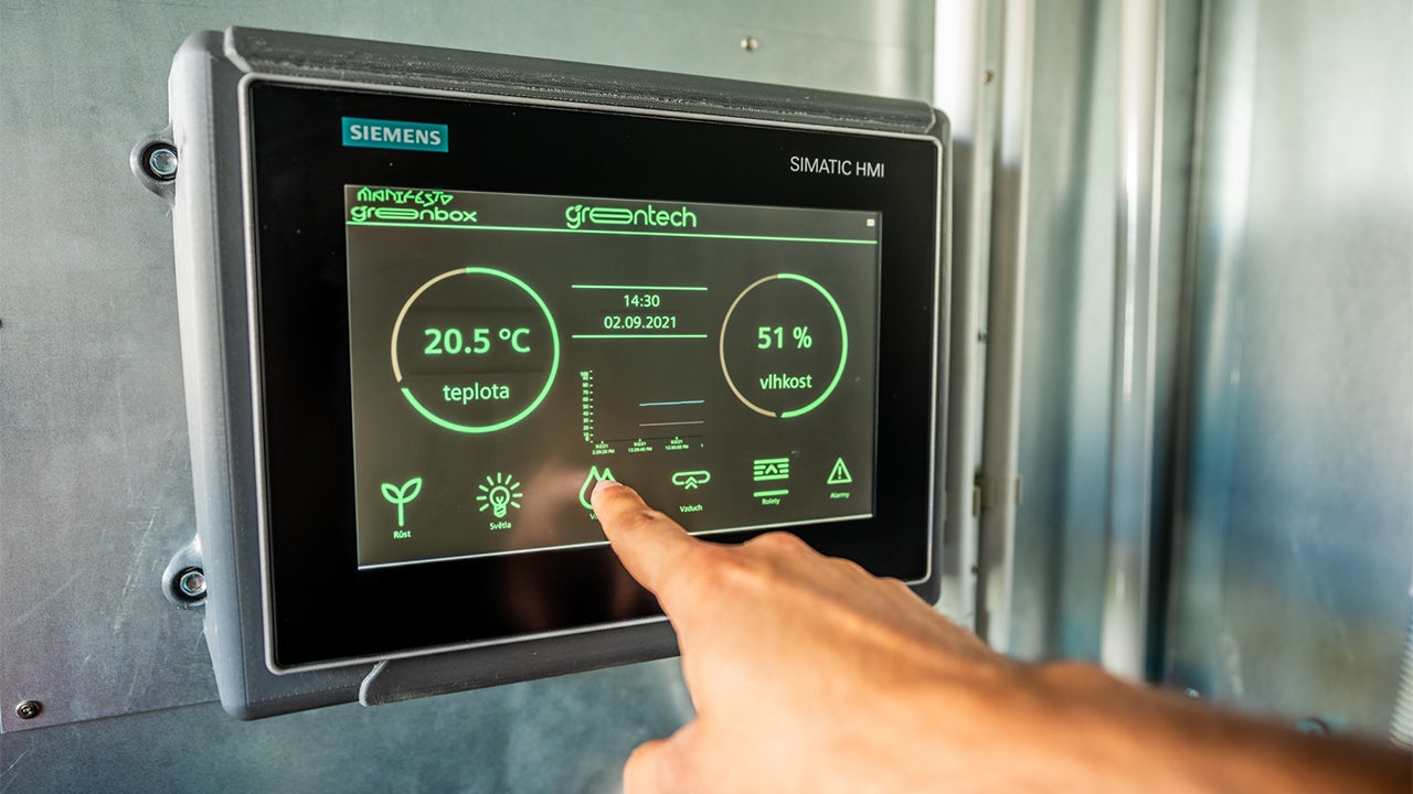 A digital control panel for an HVAC system with a display and buttons.