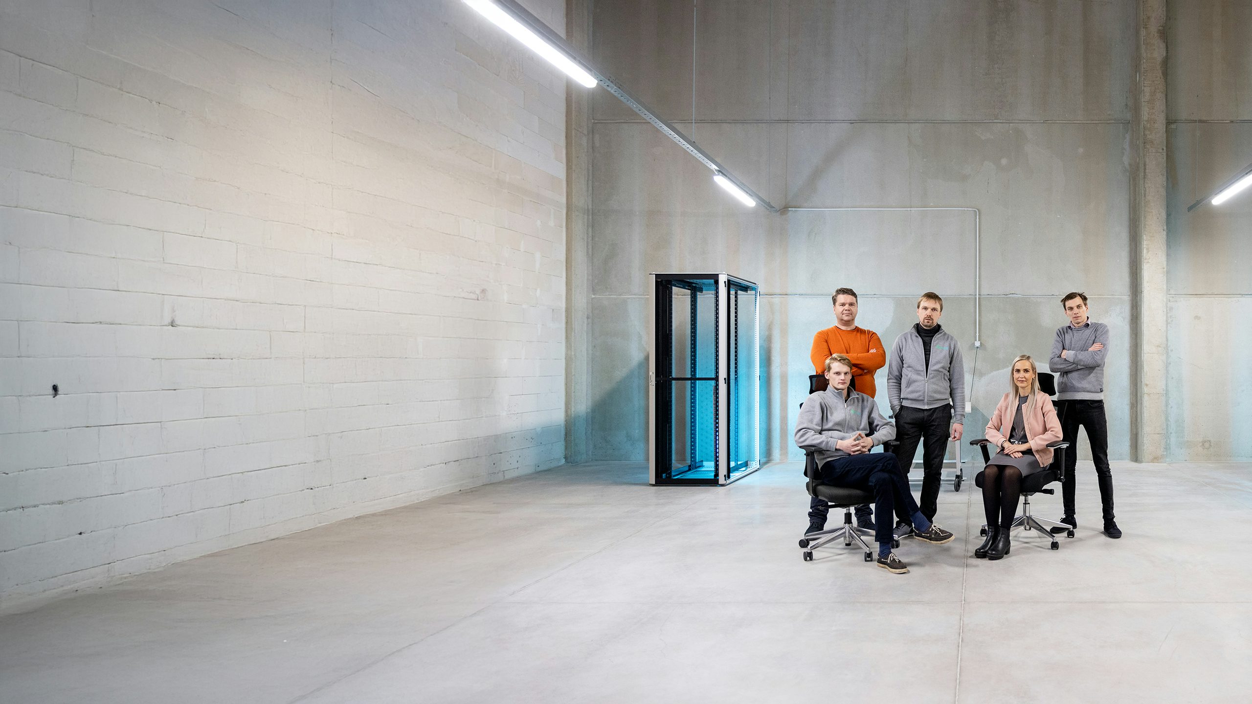 A group of people in a data center discussing green energy.