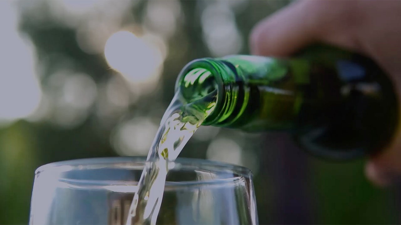 A Heineken advertisement featuring a man enjoying a beer in a bar with friends.