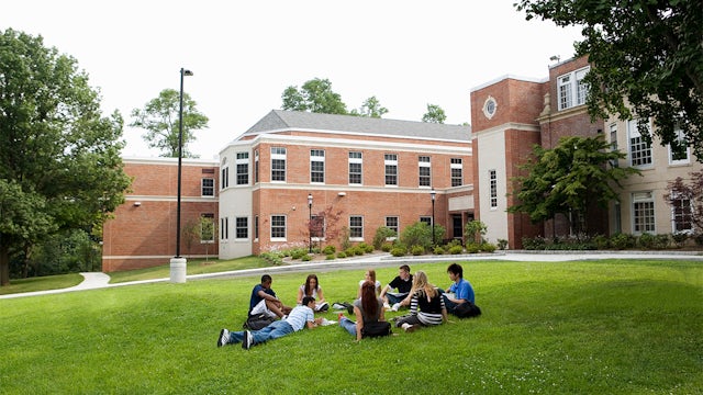 A campus with buildings and greenery, promoting sustainability in higher education.