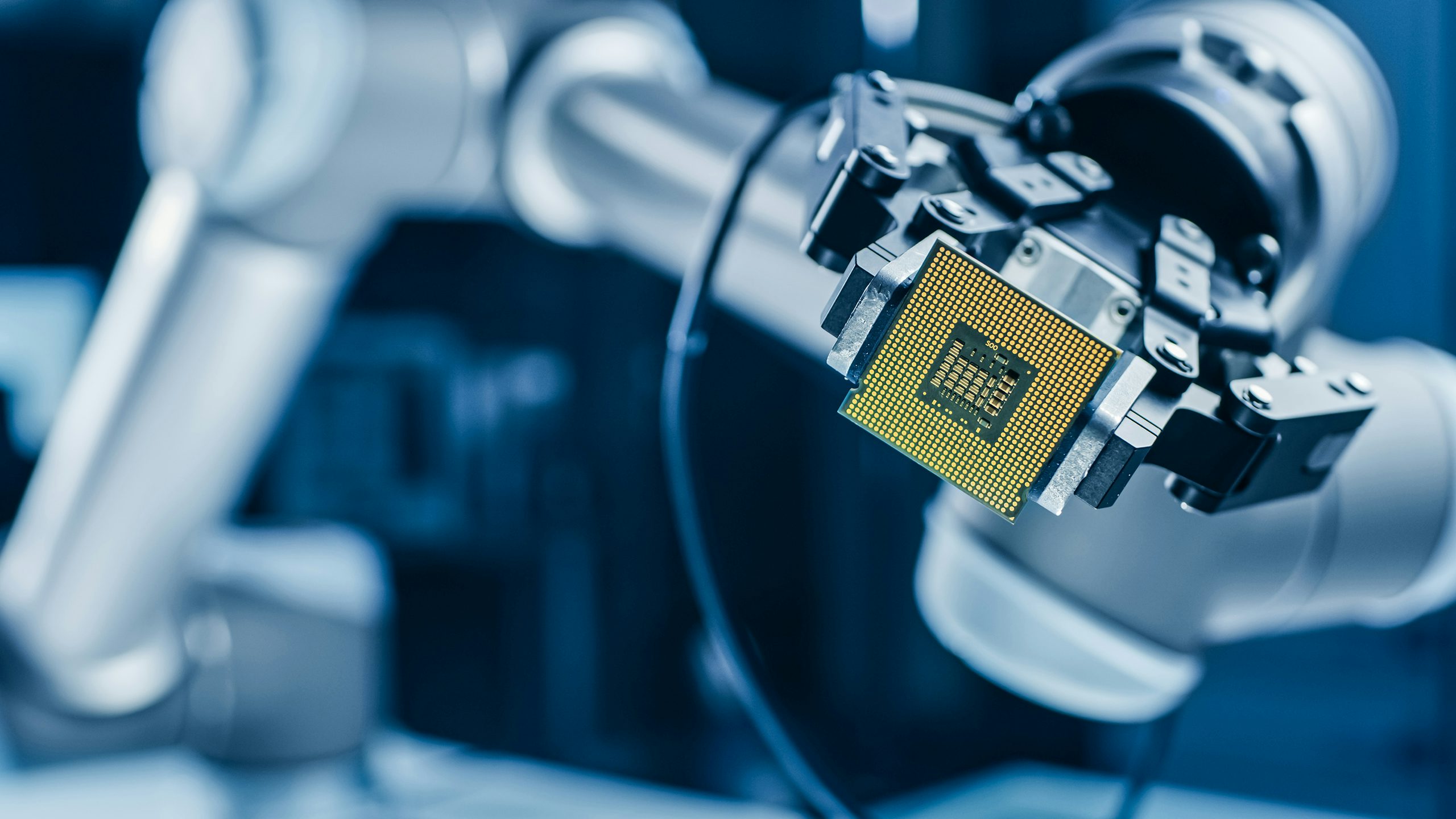 Memory IC being held by a robot arm for display.