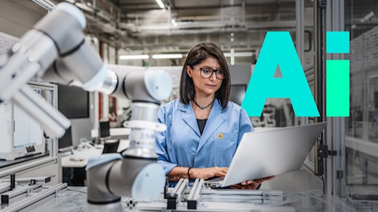 A person is standing in front of a large screen displaying a visual representation of industrial AI. 