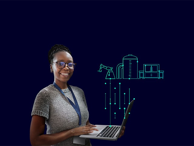 A smiling woman holding a laptop with a digital representation of industrial equipment in the background. 