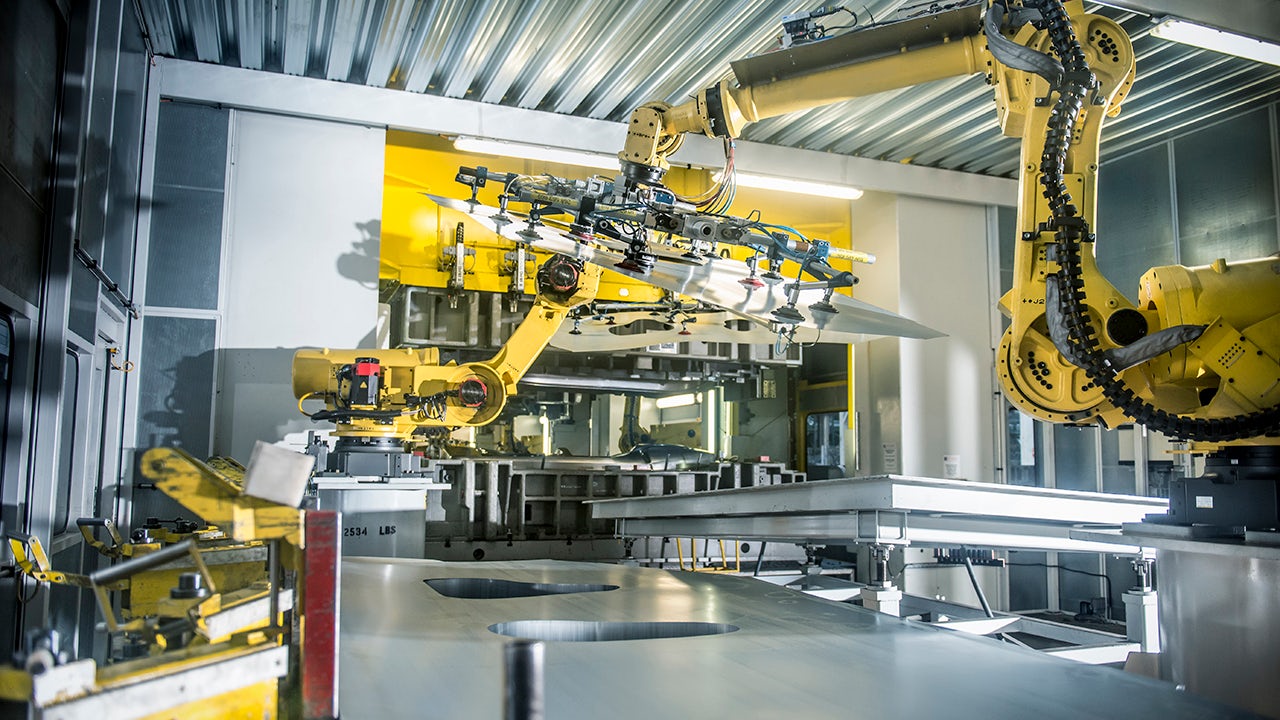 Industrial robots handling car parts in a car factory.