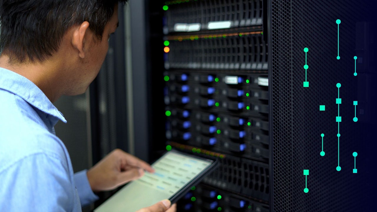 A person is working on a computer with a serious expression, possibly in an IT security setting.