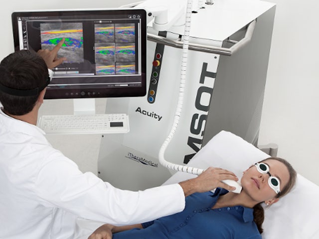 A medical device with a blue and white color scheme is displayed on a white background.