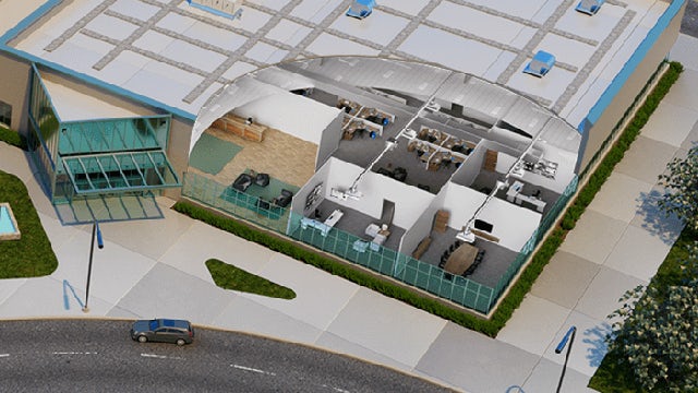 3D model of a manufacturing facility with robotic arms and conveyor belts viewed from above.