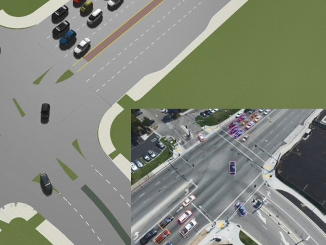 A person is driving a car on a road with a blurry background, possibly in a city.