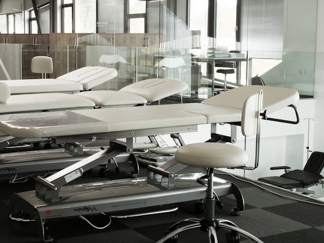 Three hospital beds lined up next to each other