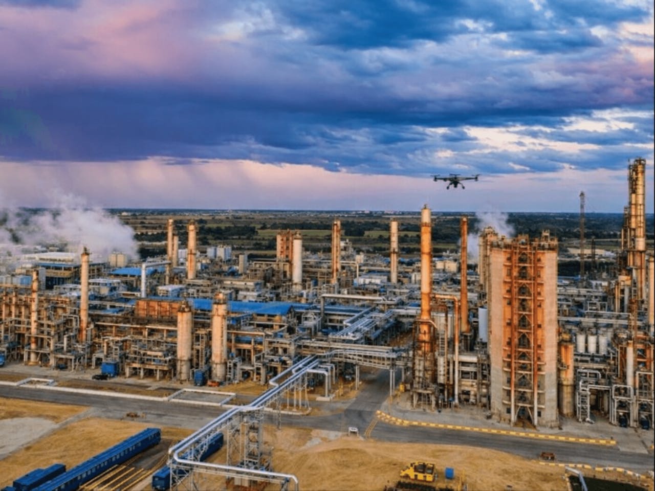 Drone over industrial complex at sunset